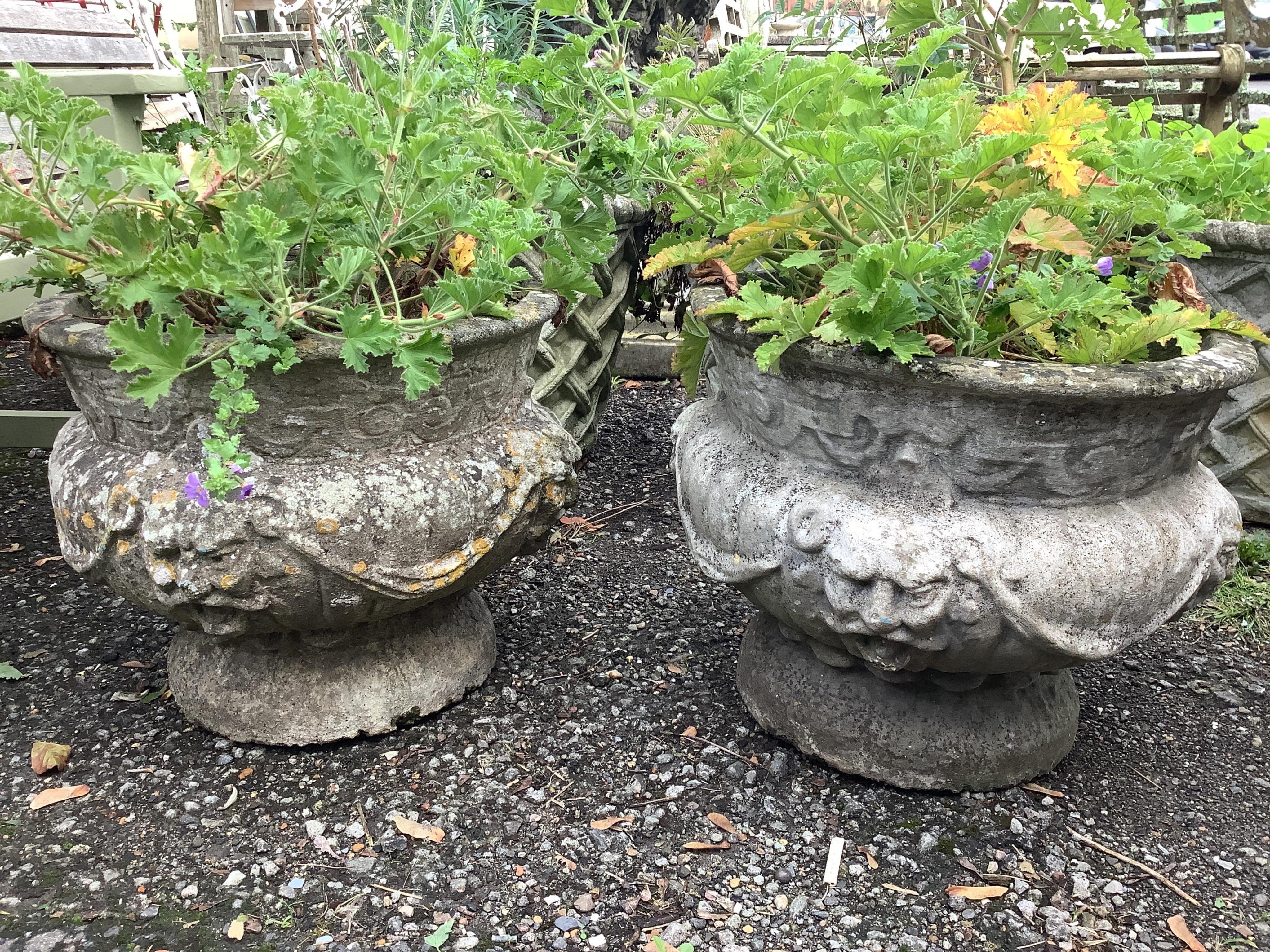 A pair of circular reconstituted stone garden planters, diameter 49cm, height 42cm. Condition - poor to fair